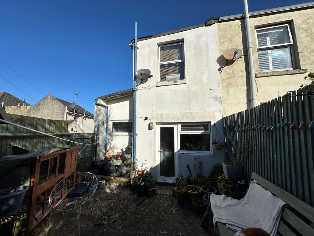 Lot: 146 - THREE-BEDROOM END-TERRACE HOUSE FOR REFURBISHMENT - Rear garden showing back of end of terrace property